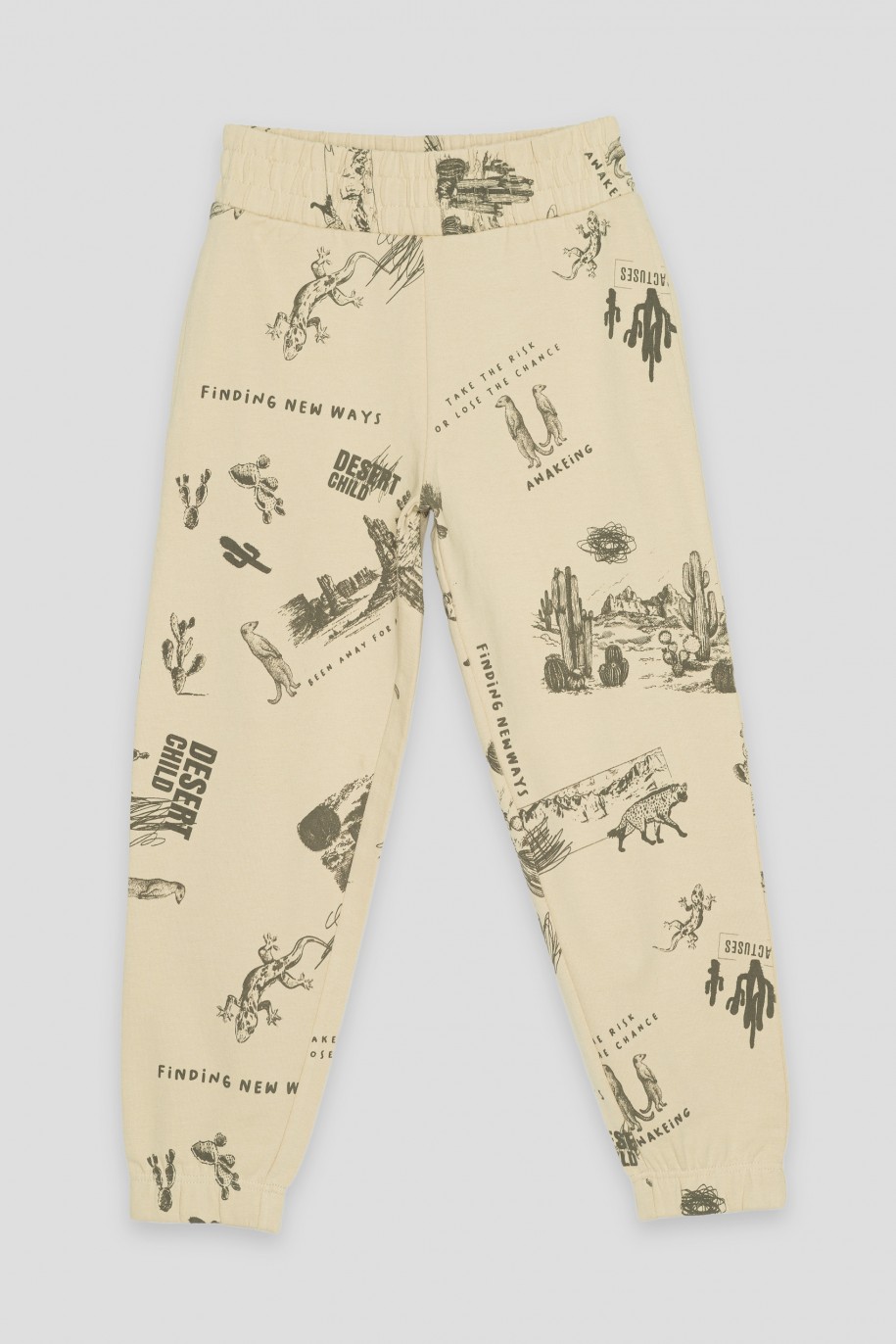 Beżowe spodnie dresowe z nadrukami - 42635