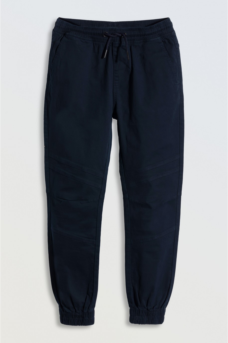 Granatowe spodnie typu joggery z modnymi przeszyciami - 46667