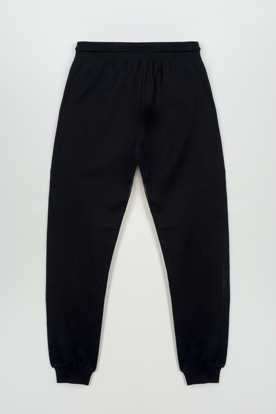 Czarne spodnie dresowe z modnymi cięciami na nogawkach - 47260